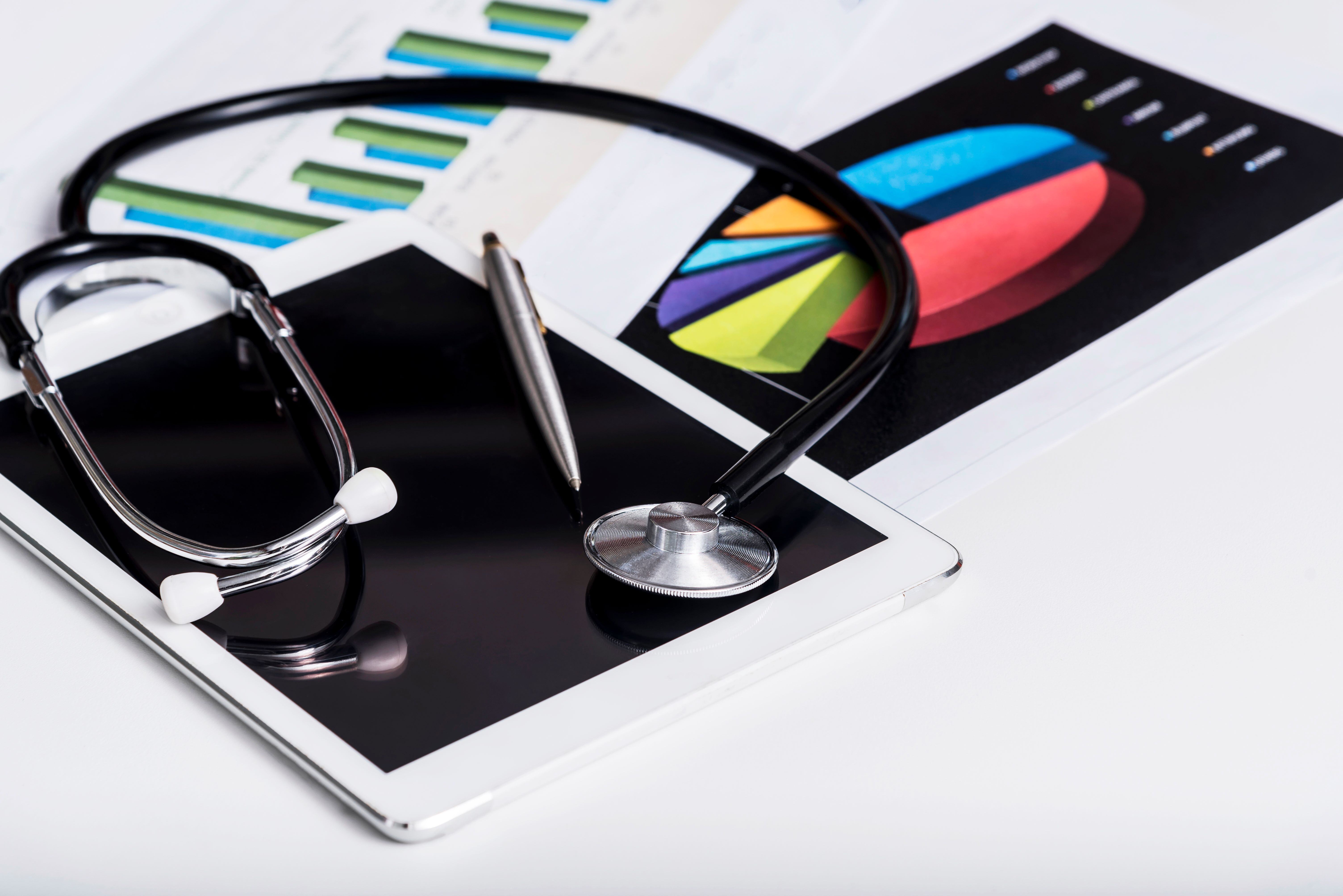 healthcare-business-concept-stethoscope-tablet-with-report-chart-paper